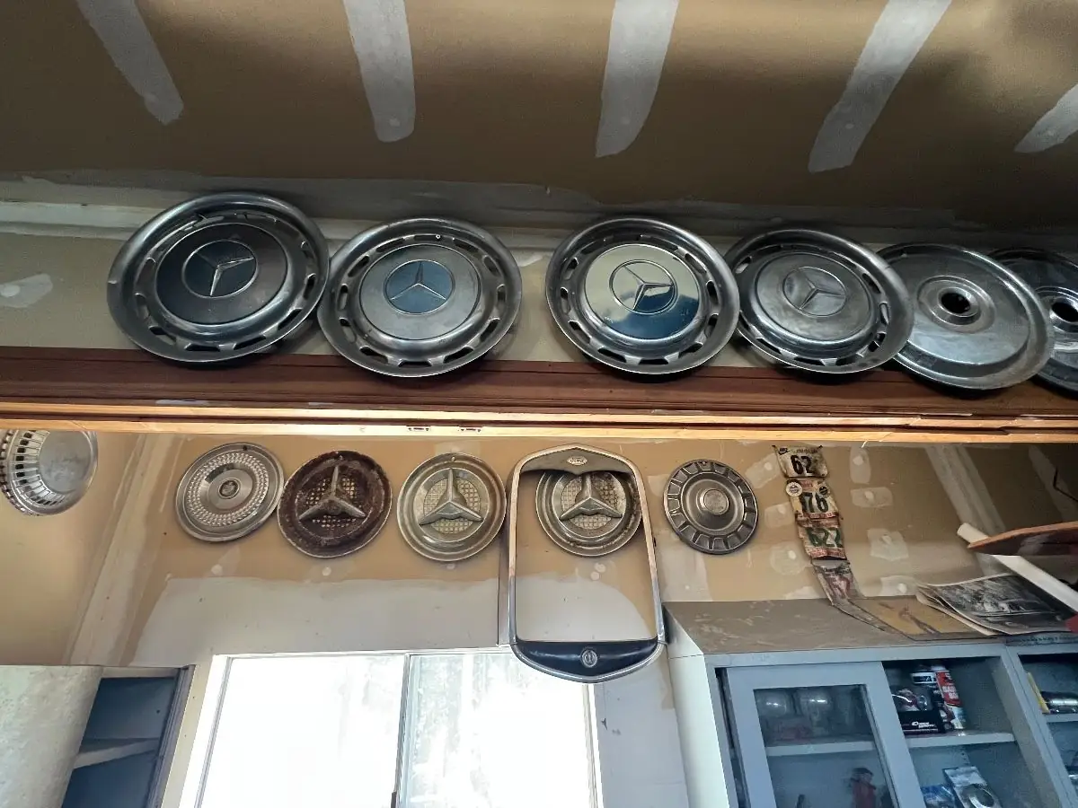 Collection of Vintage Mercedes-Benz Hubcaps and Radiator Shell