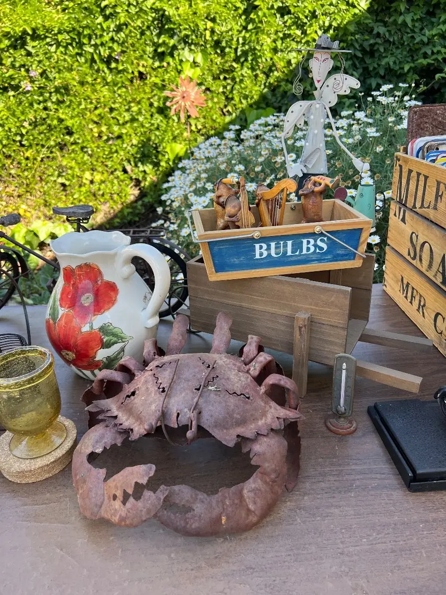 Whimsical metal garden figure with crate